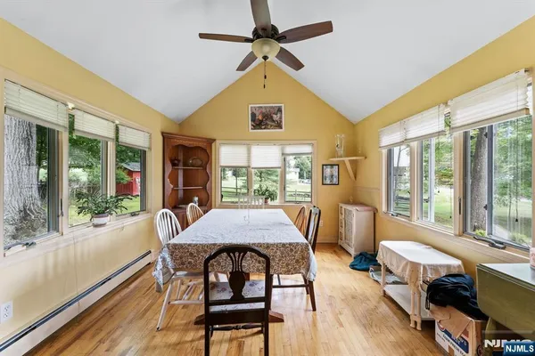 a view of a dining room with furniture window and wooden floor