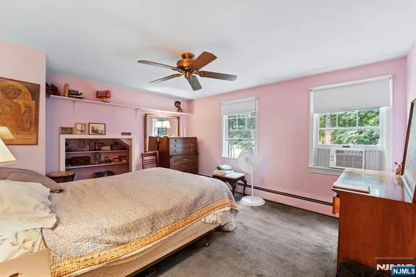 a bedroom with a bed dresser and a window