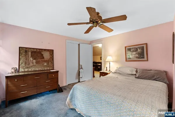 a bedroom with a bed and a painting on the wall