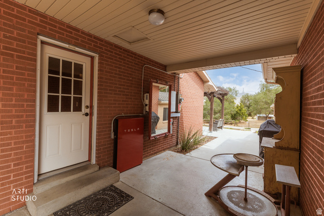 16535 South Redwood Road Riverton, UT 84065 - Photo 50 of 59 Covered patio with brick exterior walls and concrete flooring