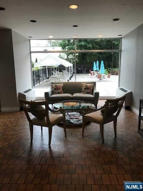 285 Aycrigg Avenue, Unit 22C Passaic, NJ 07055 - Photo 11 of 14 a living room with furniture and a large window