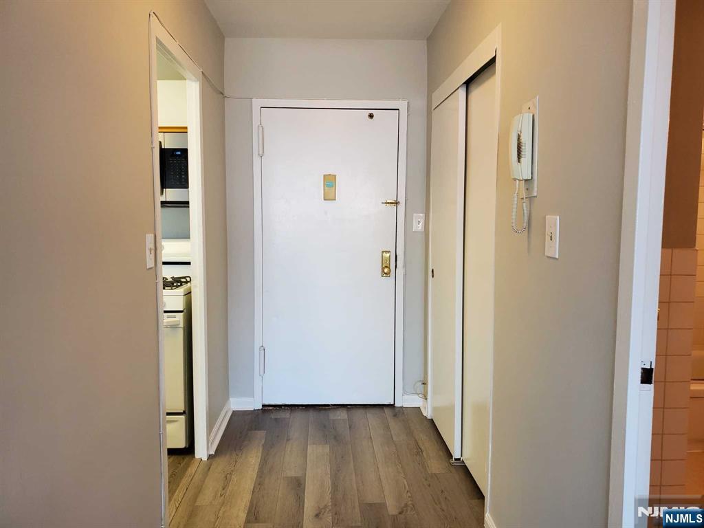 285 Aycrigg Avenue, Unit 22C Passaic, NJ 07055 - Photo 4 of 14 a view of a hallway with wooden floor and closet area