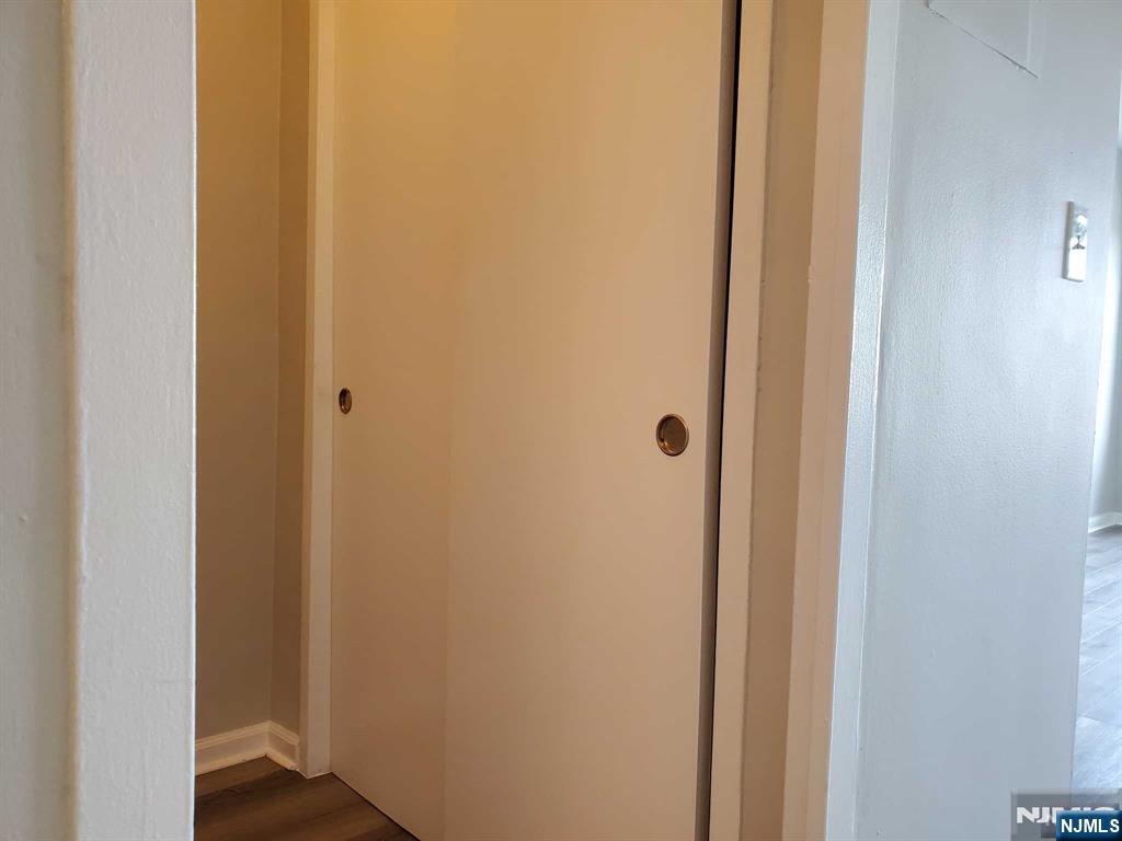 285 Aycrigg Avenue, Unit 22C Passaic, NJ 07055 - Photo 10 of 14 a view of a hallway with wooden floor