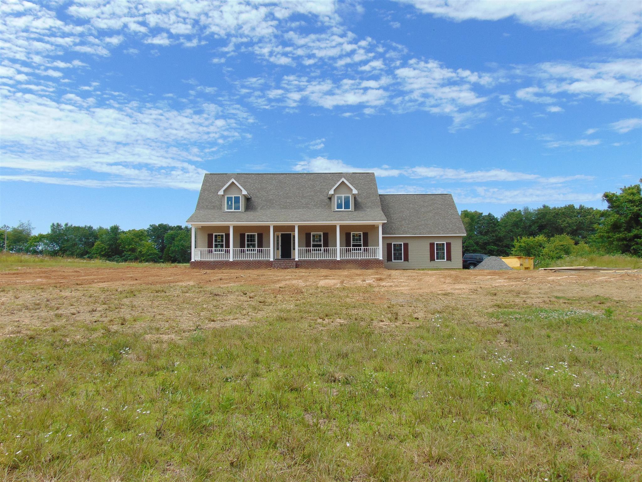 8790 Byrum Chapel Road Portland, TN 37148 - Photo 4 of 19 a front view of a house with a garden