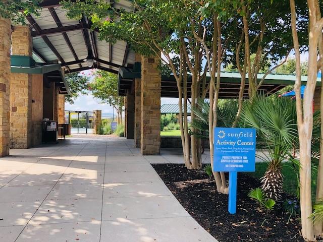252 Pond View Pass Buda, TX 78610 - Photo 36 of 37 a view of a bench sitting in front of a building