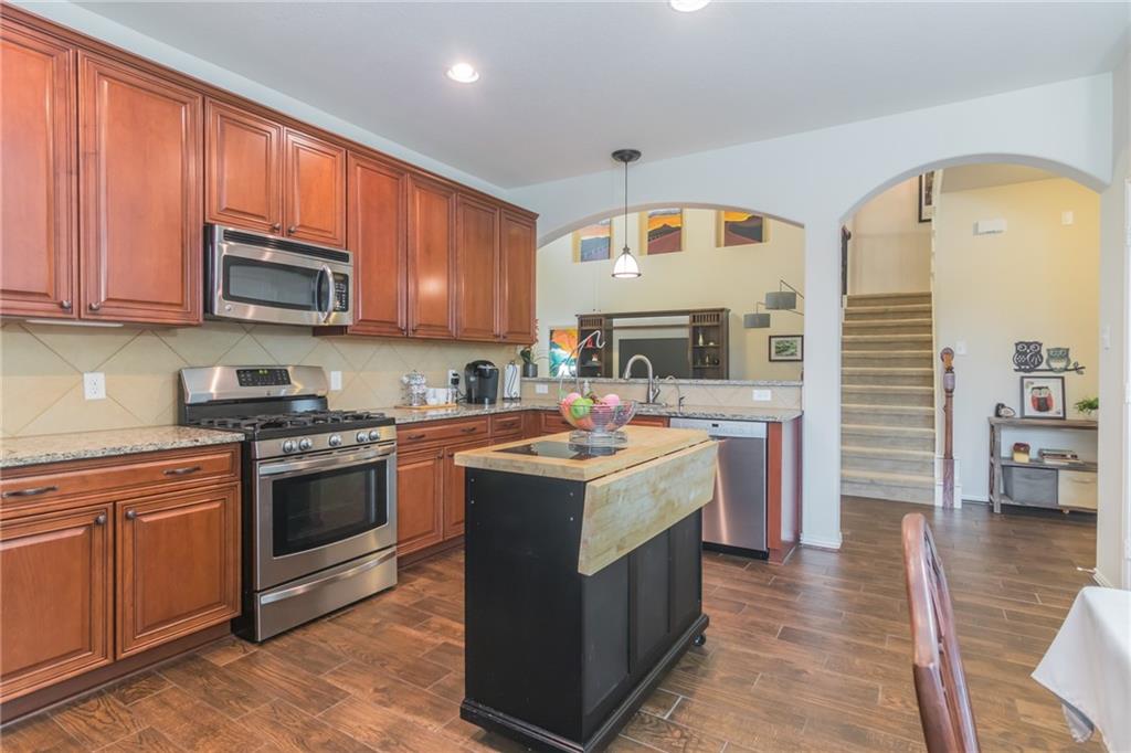 252 Pond View Pass Buda, TX 78610 - Photo 9 of 37 a kitchen with a sink stove and cabinets