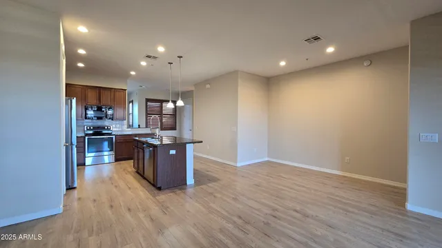 a kitchen with a refrigerator and a wooden cabinets
