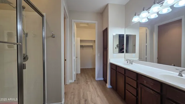 a spacious bathroom with a double vanity sink and a mirror