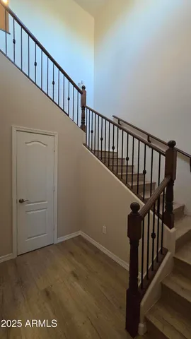 a view of staircase with railing and white walls