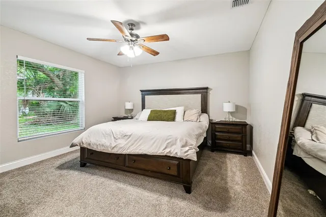 a bedroom with a bed and a large window