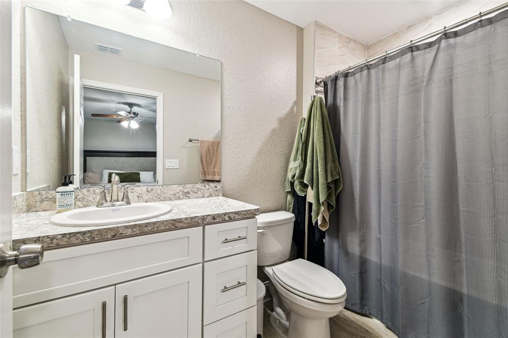 524 Carroll Avenue Lakeland, FL 33815 - Photo 17 of 33 a bathroom with a granite countertop sink toilet and mirror
