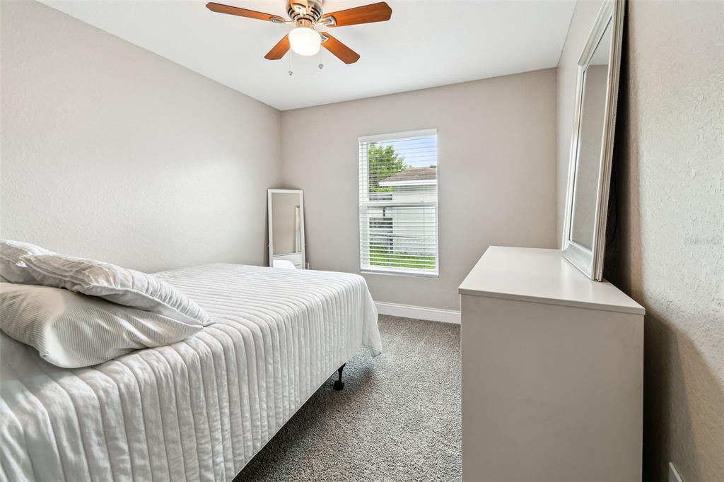 524 Carroll Avenue Lakeland, FL 33815 - Photo 18 of 33 a bedroom with a bed and a chandelier