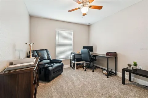 a view of a workspace with furniture and a window