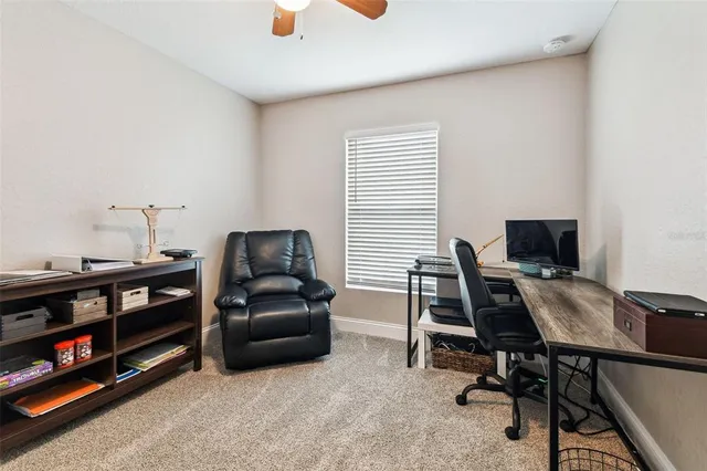 a livingroom with workspace and a window