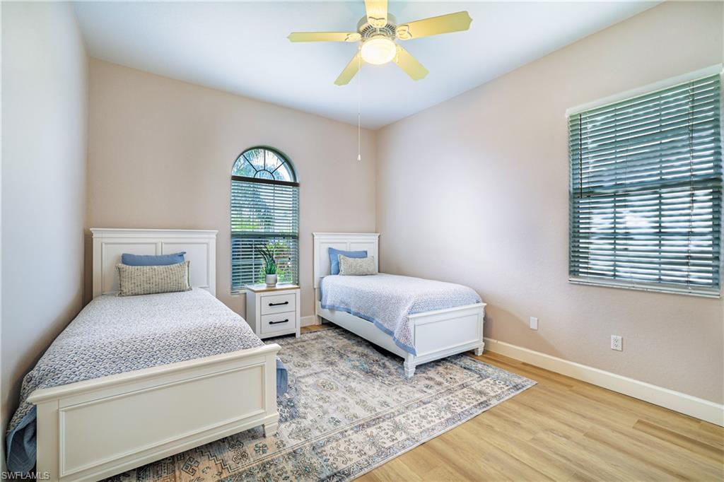5235 Malvern Court Naples, FL 34112 - Photo 19 of 28 a bedroom with a bed and a window