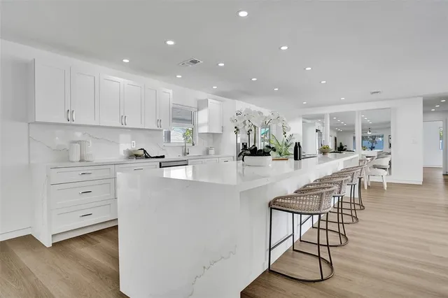 a open kitchen with stainless steel appliances granite countertop a lot of counter space and wooden floor