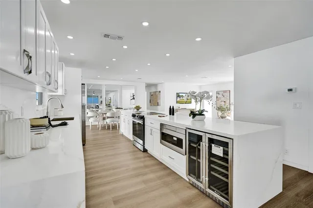 a kitchen with a refrigerator and a stove top oven