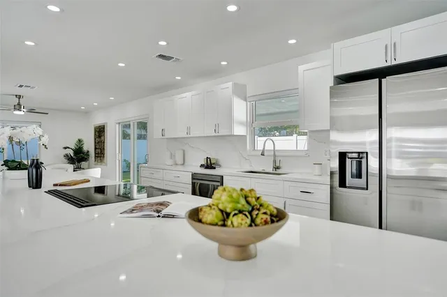 a dining room with furniture and a large window