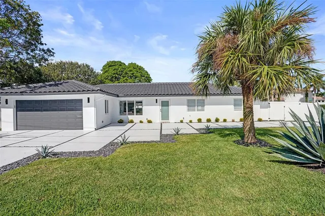 a view of a house with a backyard and a patio