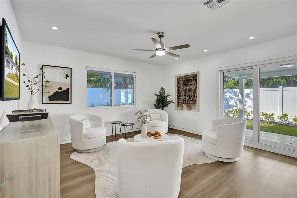 699 Northeast 70th Street Boca Raton, FL 33487 - Photo 25 of 66 a living room with furniture and a large window