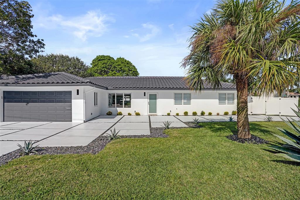 699 Northeast 70th Street Boca Raton, FL 33487 - Photo 3 of 66 a view of a house with a backyard and a patio