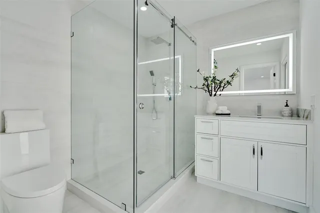 a bathroom with a sink toilet and shower