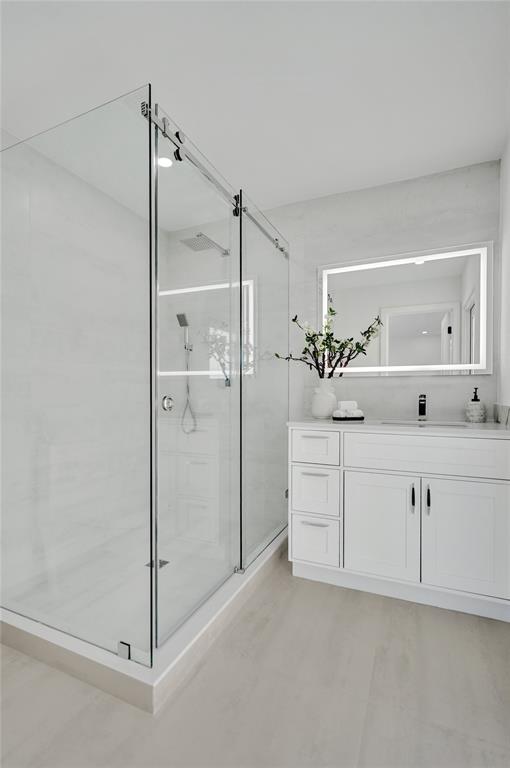 699 Northeast 70th Street Boca Raton, FL 33487 - Photo 35 of 66 a bathroom with a shower sink and mirror