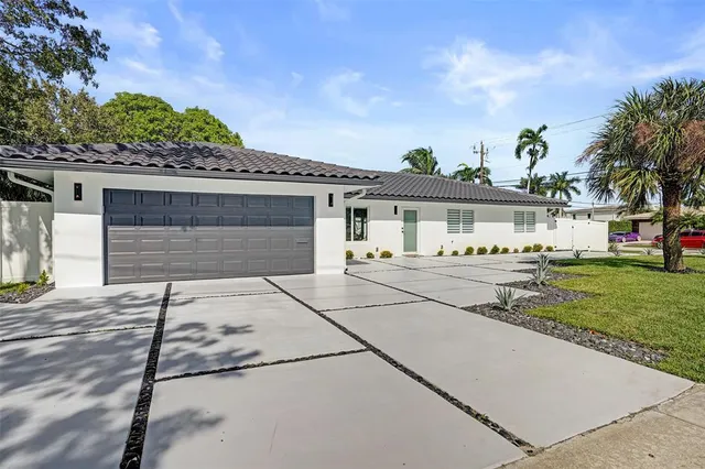 a dining room with furniture and a potted plant