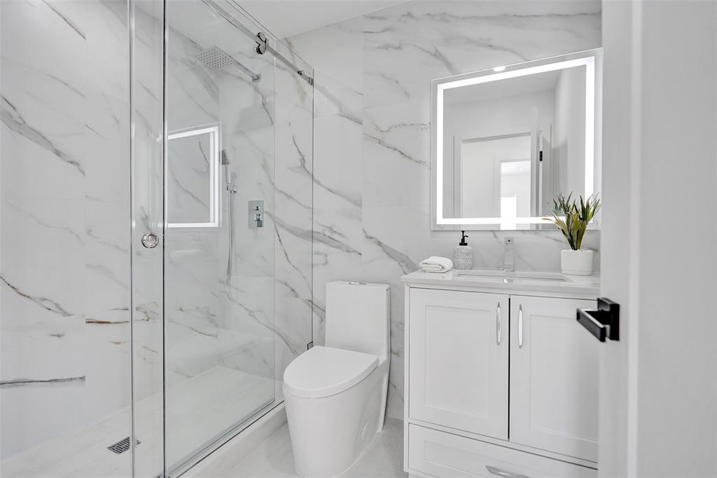 699 Northeast 70th Street Boca Raton, FL 33487 - Photo 41 of 66 a bathroom with a sink toilet and shower