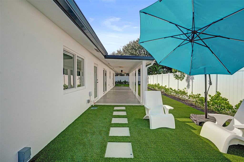 699 Northeast 70th Street Boca Raton, FL 33487 - Photo 49 of 66 a view of a house with a yard porch and furniture