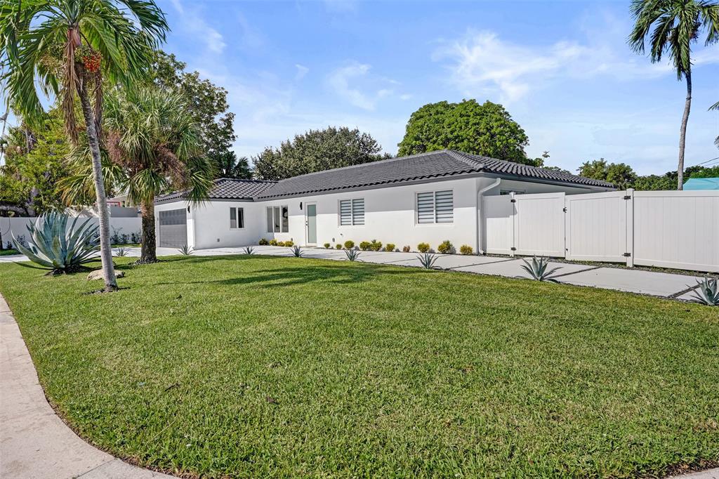 699 Northeast 70th Street Boca Raton, FL 33487 - Photo 60 of 66 a view of a house with a yard