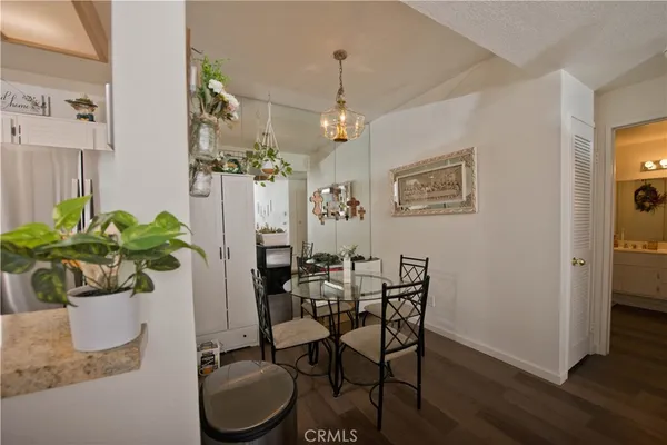 a kitchen with a sink a refrigerator a microwave and cabinets