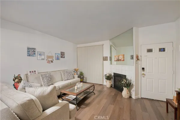 a living room with furniture a clock on wall and a window