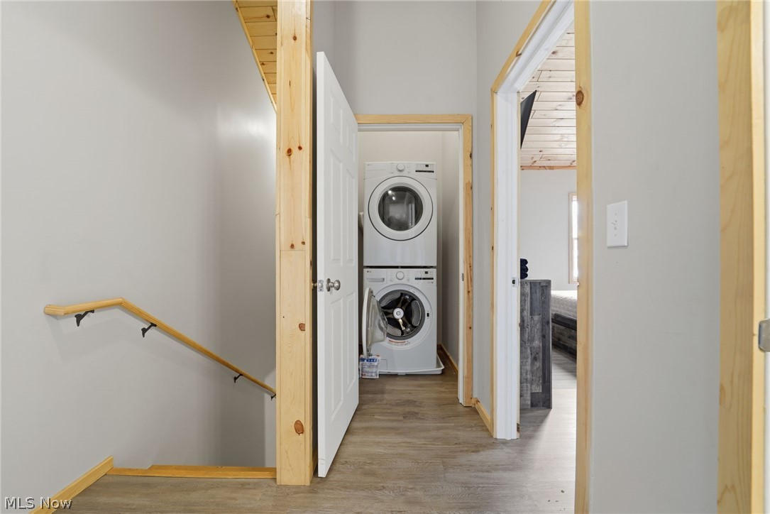 5919 Lake Road West, Unit 33 Ashtabula, OH 44004 - Photo 19 of 22 Laundry area featuring stacked washer and dryer and light wood finished floors