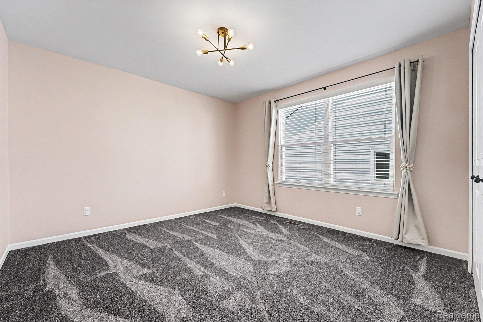 2471 Massoit Road Royal Oak, MI 48073 - Photo 25 of 49 Spare room with carpet floors and a chandelier