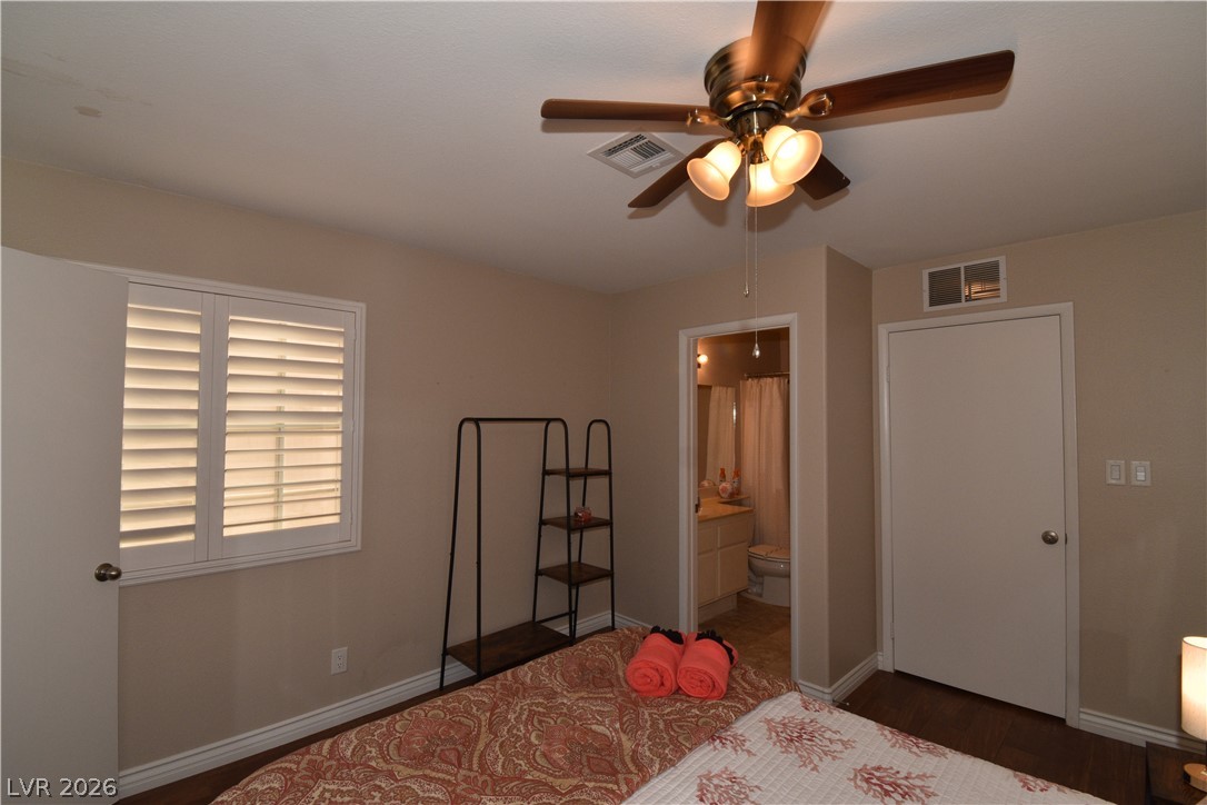 267 Westwind Road Henderson, NV 89074 - Photo 21 of 27 Comfortable bedroom retreat with practical ceiling fan and direct access to a bathroom.