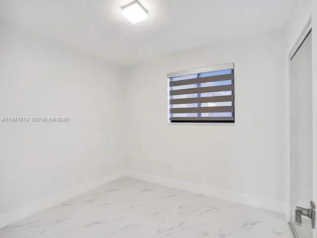 a view of empty room with windows