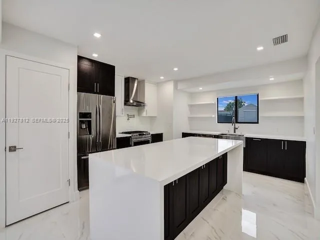 a large kitchen with a large counter top appliances and cabinets