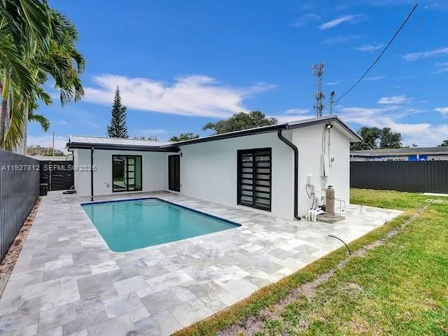 a view of a house with backyard and sitting area