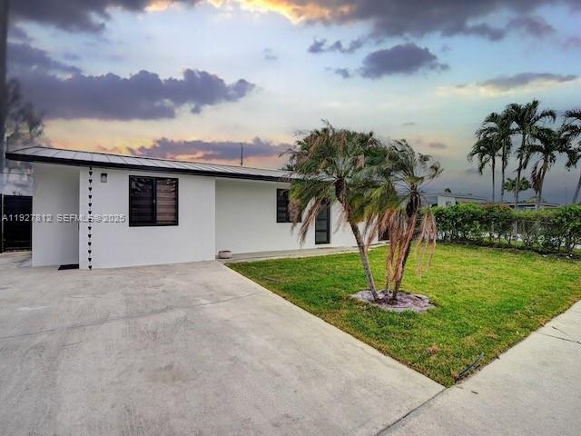7881 Hope Street Hollywood, FL 33024 - Photo 5 of 39 a front view of a house with a yard and palm trees