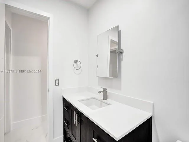 a bathroom with a sink vanity and a mirror
