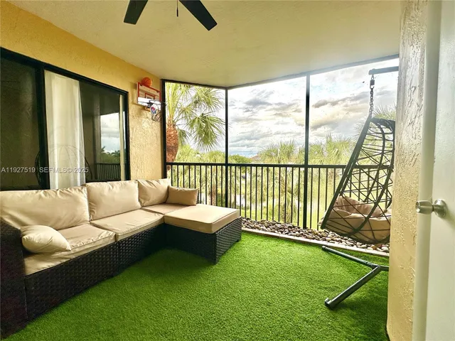 a living room with furniture and a floor to ceiling window