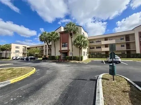 a front view of a house with swimming pool and outdoor seating