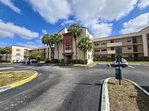 3470 Foxcroft Road, Unit 308 Miramar, FL 33025 - Photo 14 of 15 a front view of a house with swimming pool and outdoor seating