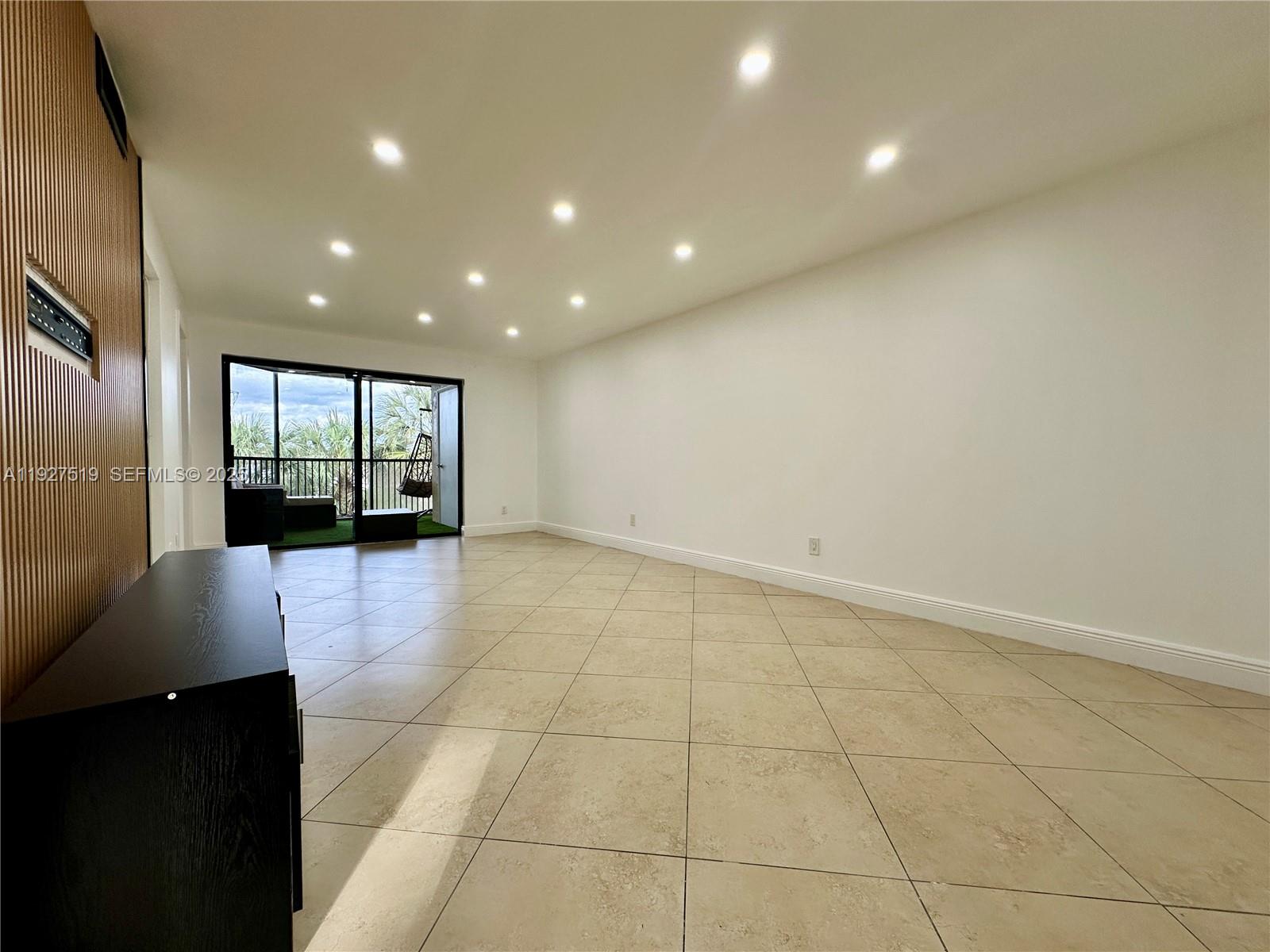 3470 Foxcroft Road, Unit 308 Miramar, FL 33025 - Photo 7 of 15 a view of an empty room with wooden floor and a bathroom