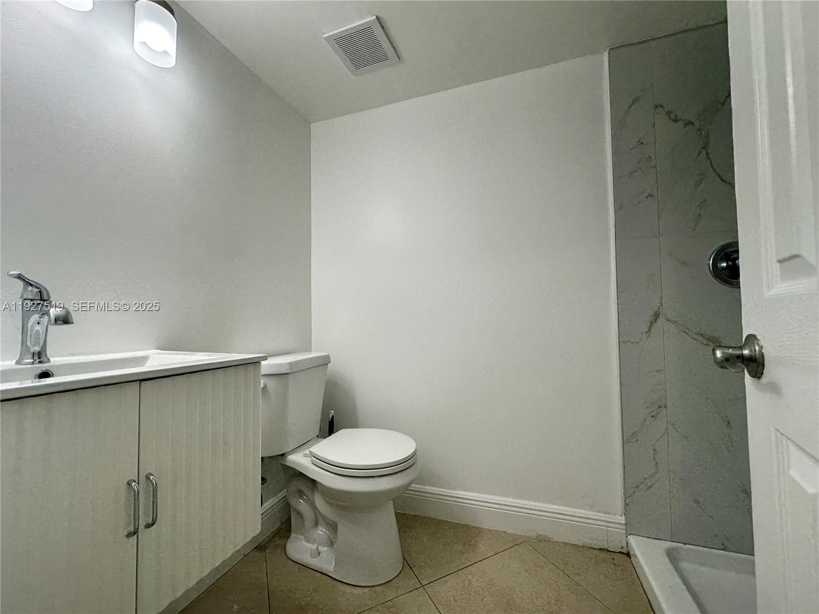 3470 Foxcroft Road, Unit 308 Miramar, FL 33025 - Photo 10 of 15 a white toilet sitting next to a bathroom sink