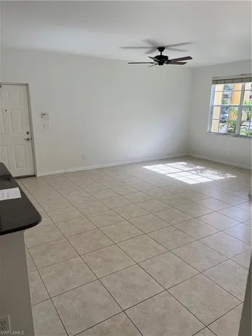a view of a livingroom with a dishwasher cabinets and a window