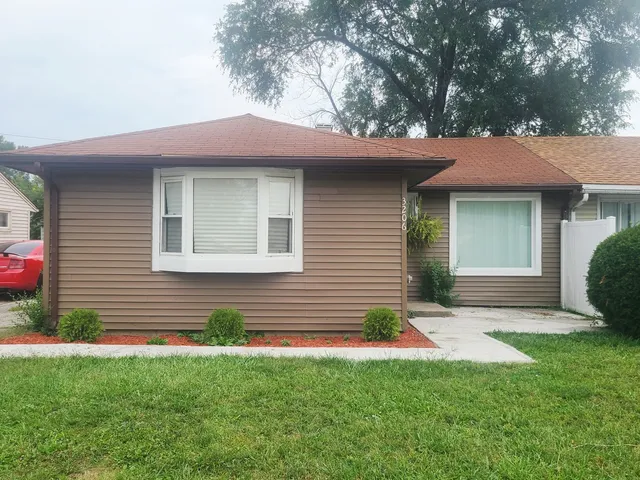 a backyard of a house with table and chairs