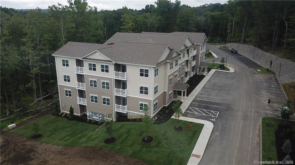 9 Covered Bridge Road, Unit 2205 Newtown, CT 06470 - Photo 1 of 1 a view of a big house with a big yard plants and large trees