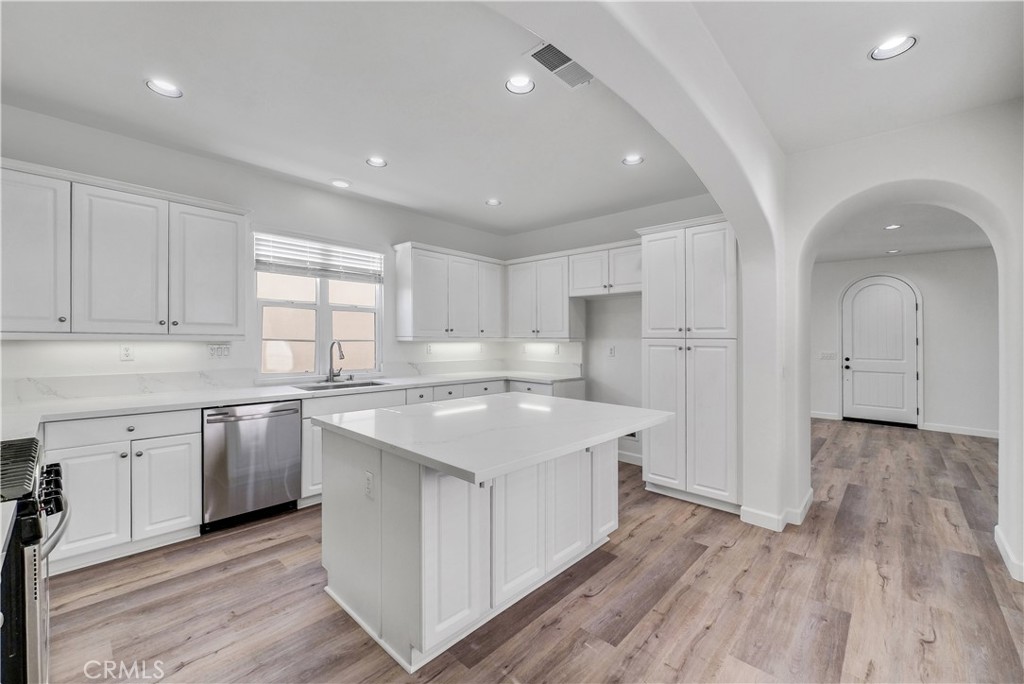 180 Heartwood Way Anaheim, CA 92801 - Photo 12 of 38 a kitchen with white cabinets appliances and sink